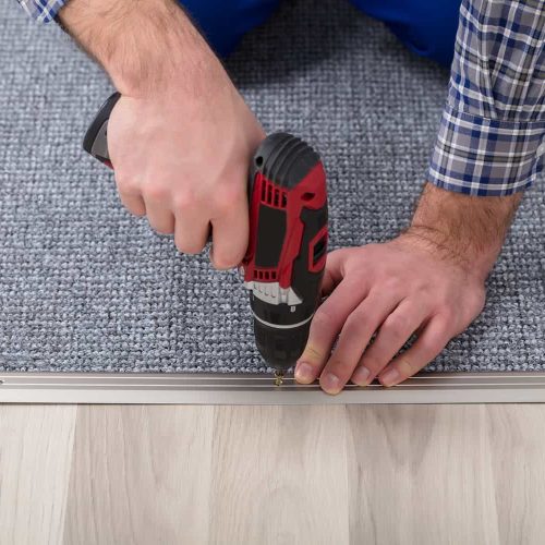 bigstock-Carpet-Fitter-Installing-Carpe-235837375